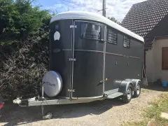 Un van oblic 2 places Fautras, gris foncé, prêt pour transporter vos chevaux.
